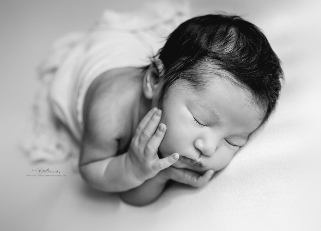 newborn hands on chin